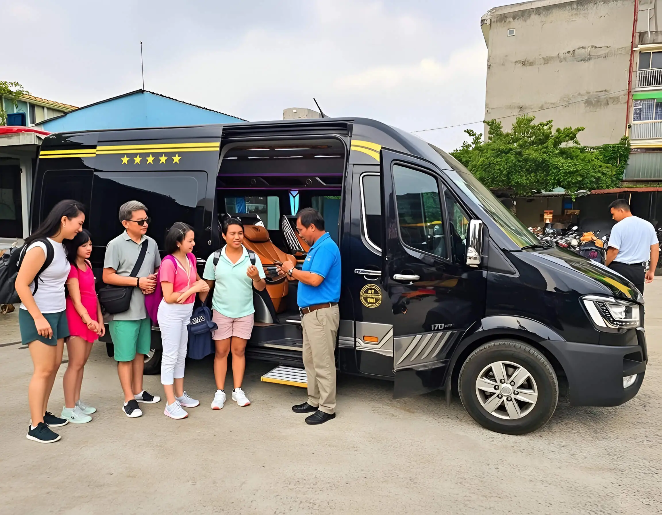 A professional private driver in a blue uniform standing beside a long-distance passenger van while greeting a family of four tourists.