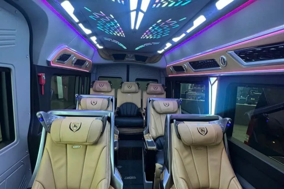 16-seater van interior configured for long-distance night transfers.