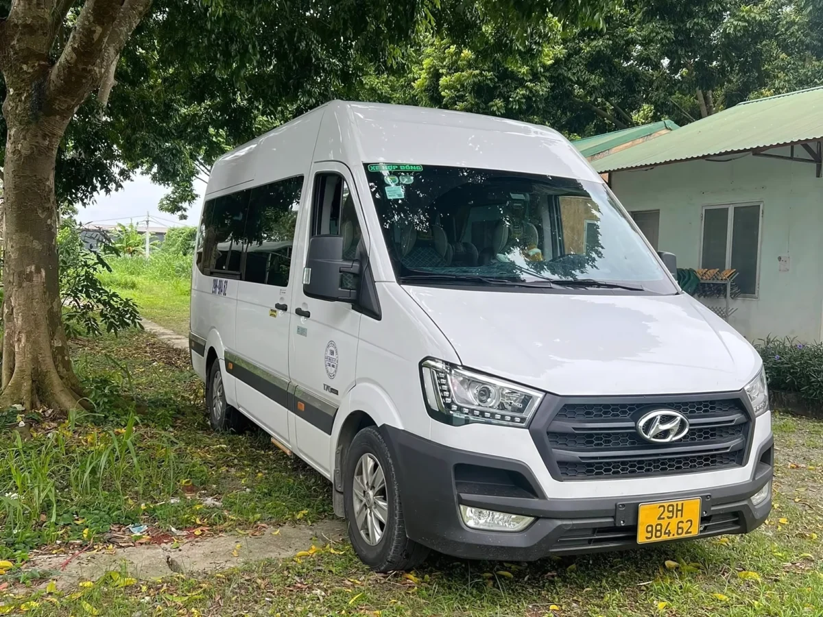 White Hyundai Solati 16-seat high-roof van — Hanoi to Ha Long Bay group transfer