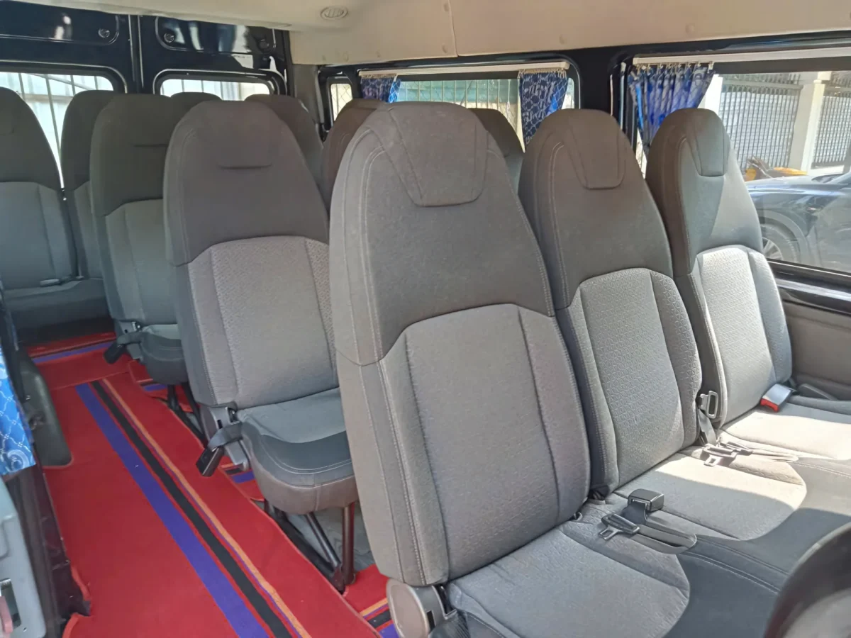 Rows of clean grey passenger seats — 16-seat private van for Hanoi Ha Long Bay transfer