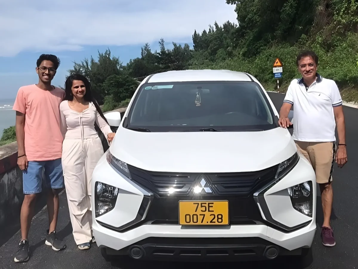 Passengers with their private car at a coastal viewpoint — Hanoi Ha Long Bay transfer