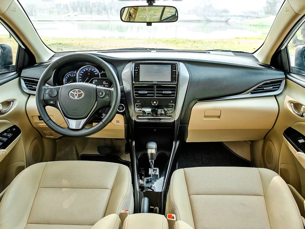 Clean dashboard and beige leather seats inside a 5-seat private car