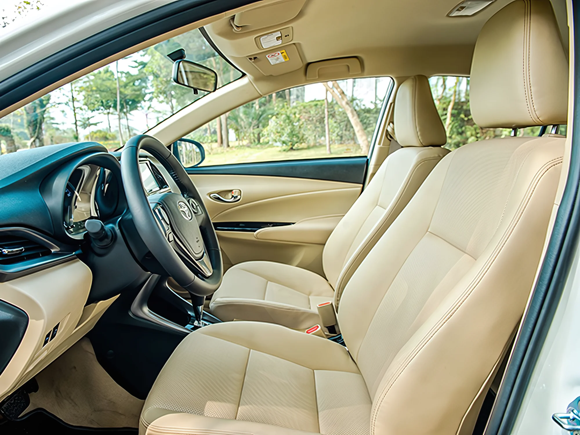 Beige leather driver and passenger seats in a Private Vietnam sedan