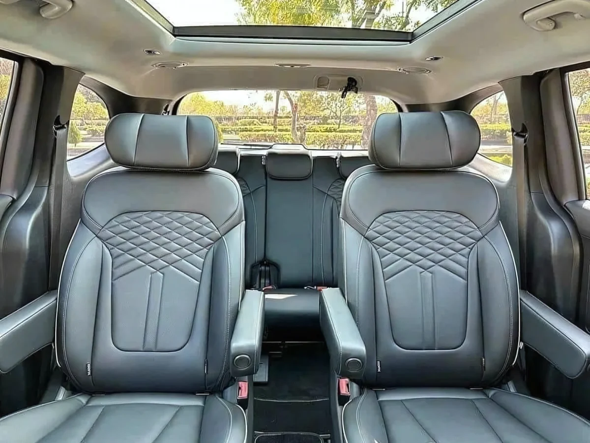 Black quilted leather captain chairs in a Private Vietnam 7-seat vehicle