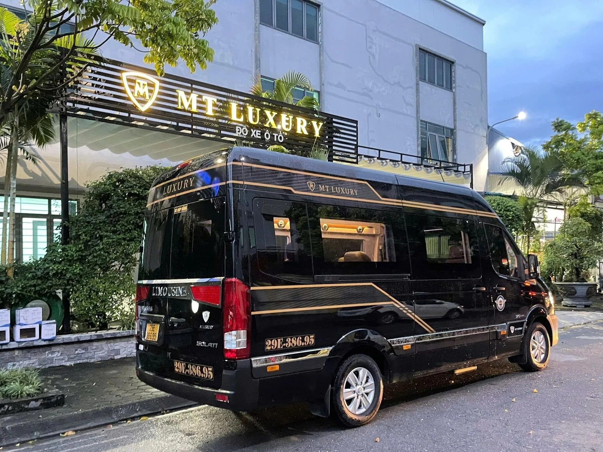 Black VIP limousine van photographed at night — night departures available