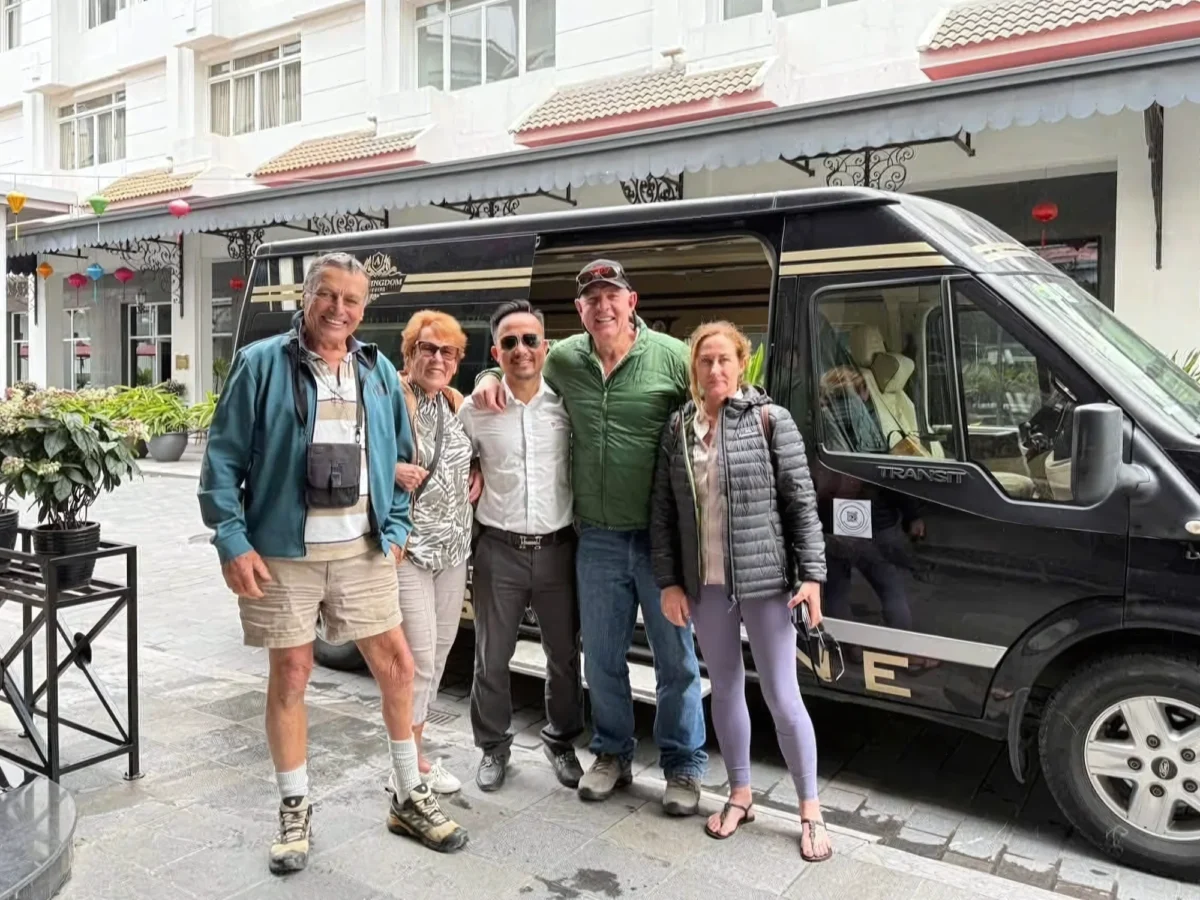 International travellers beside a Private Vietnam VIP van — Hanoi to Ha Long Bay transfer