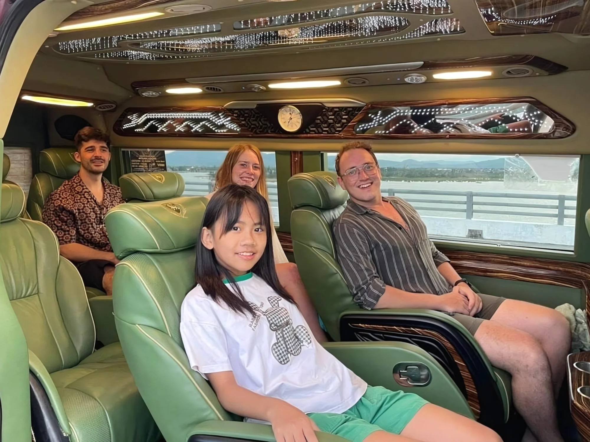 Passengers relaxing in a VIP private van with scenic views through the windows