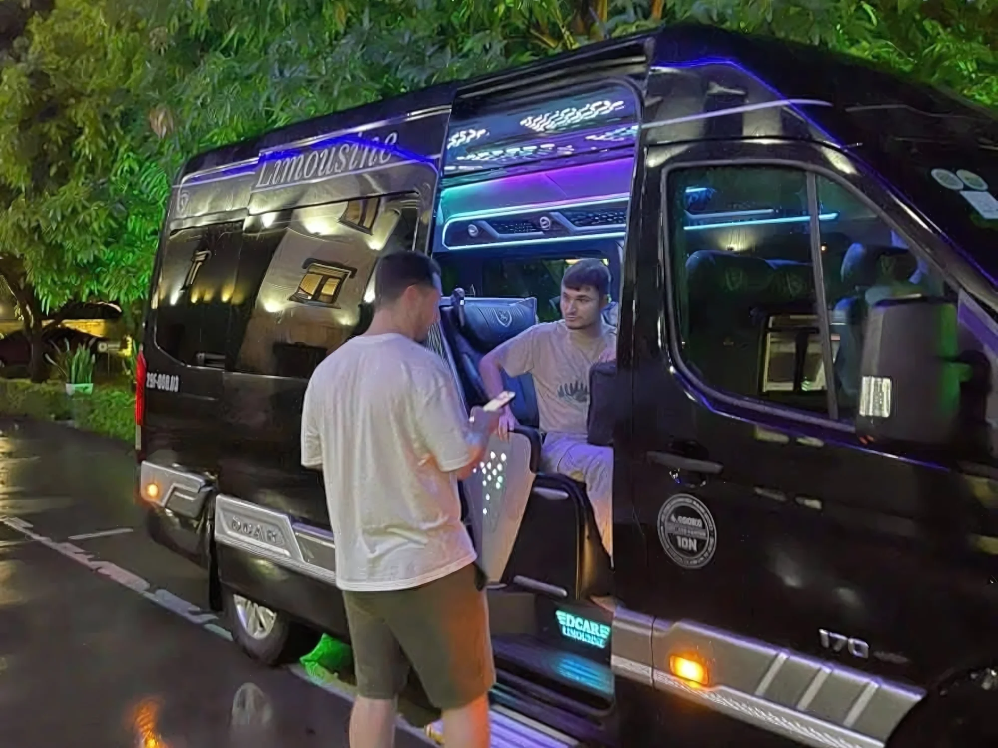 Young travellers boarding a Private Vietnam VIP van at night