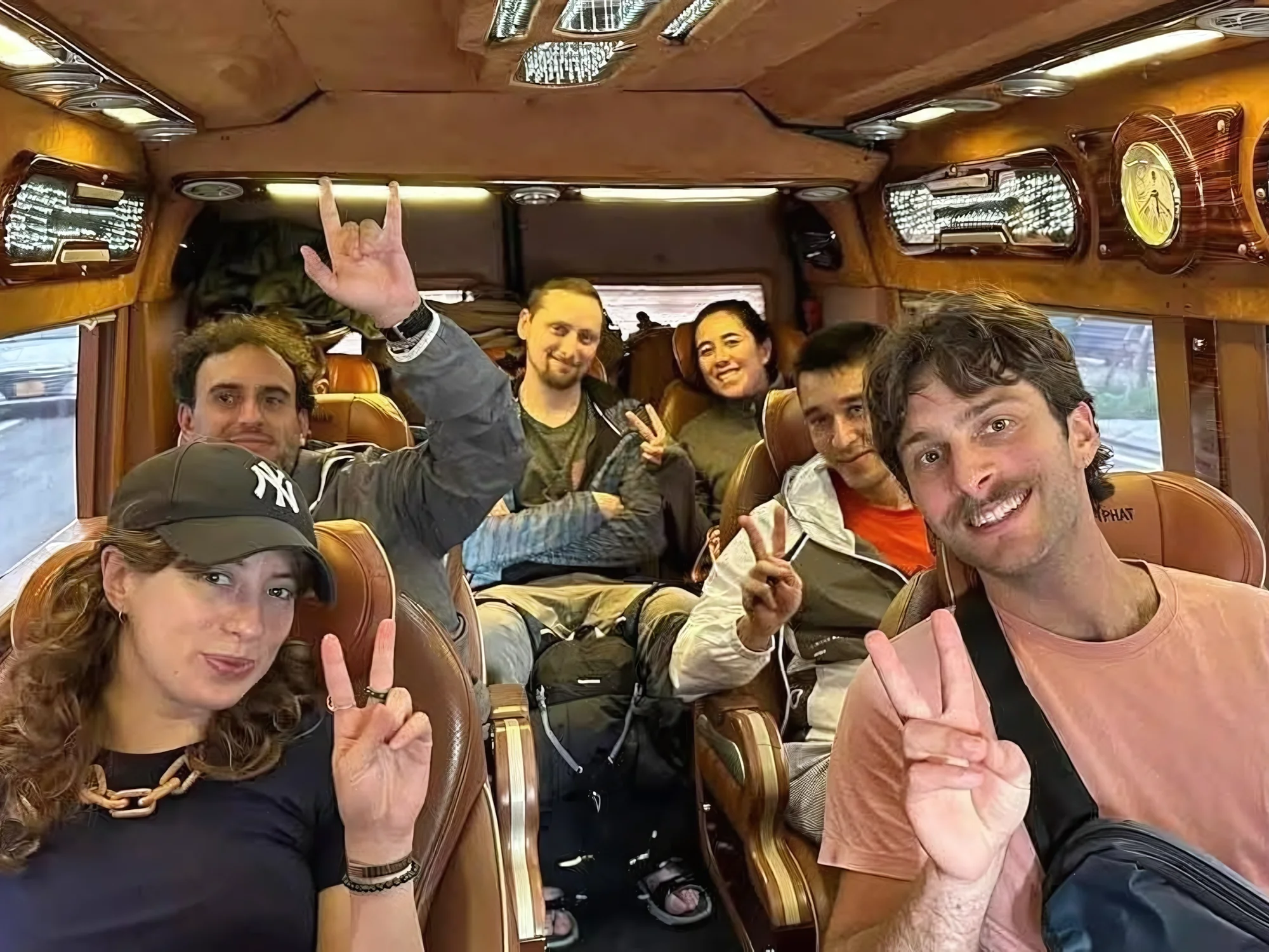 Group of friends relaxing in a Private Vietnam VIP lounge van configuration