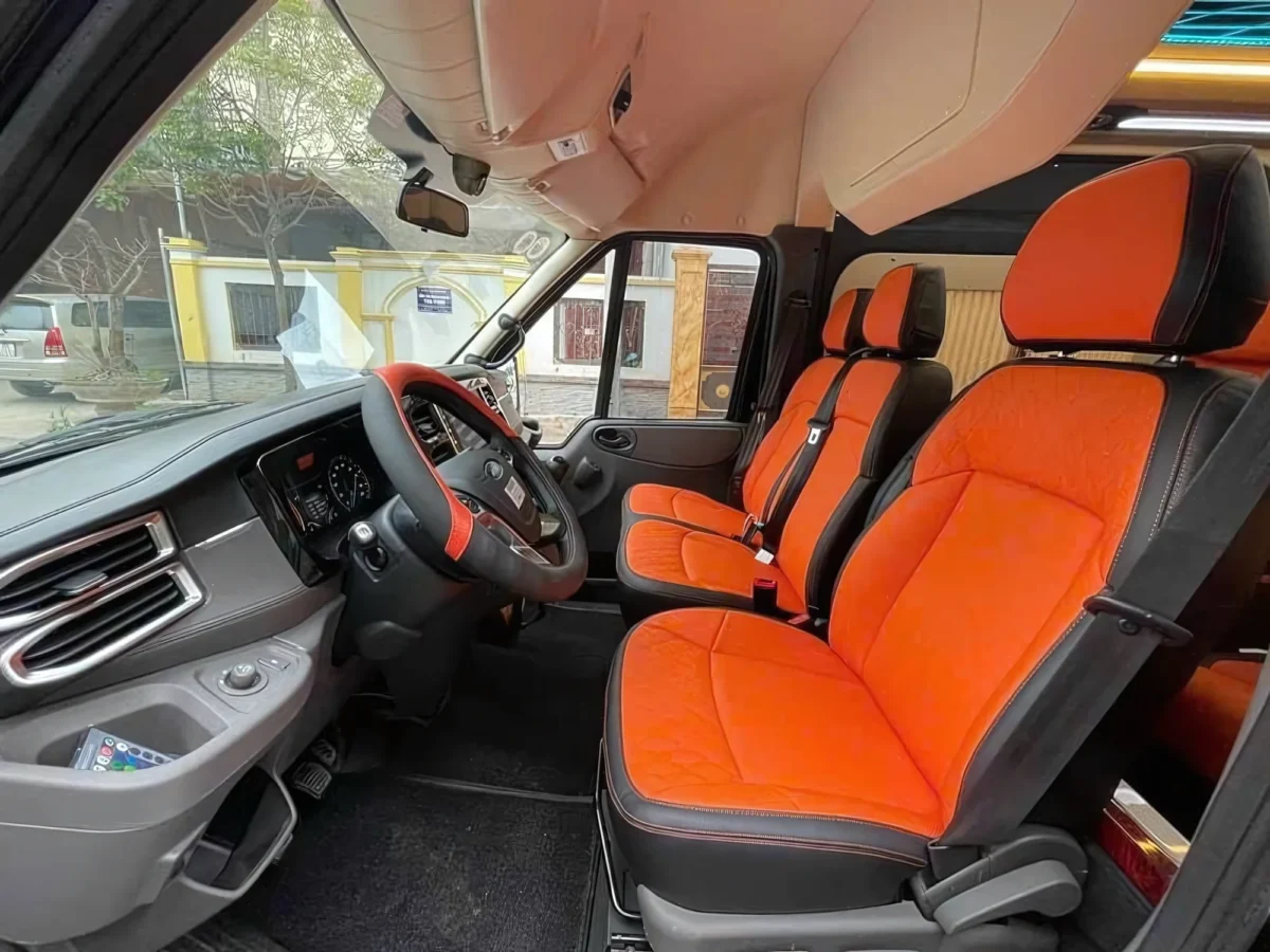 Front cabin of a Private Vietnam VIP van — premium dashboard and dual screens