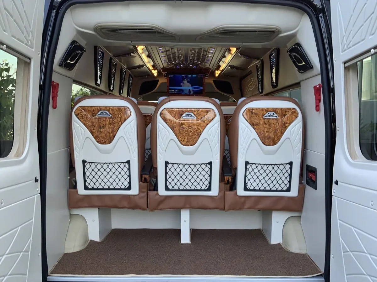 Rear interior of a VIP private van with mesh seat-back storage pockets
