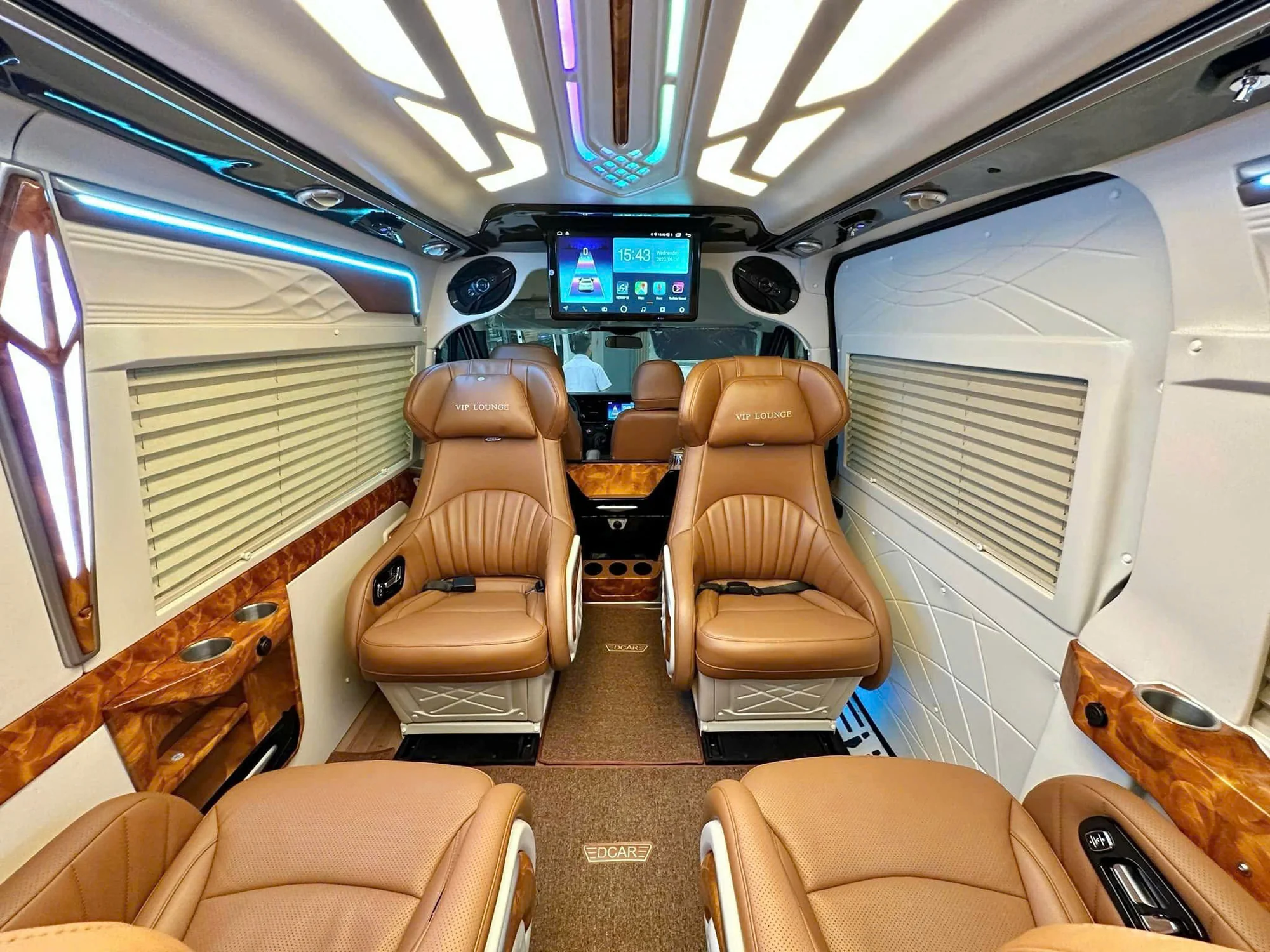 Brown leather rear lounge sofa inside a Private Vietnam VIP van